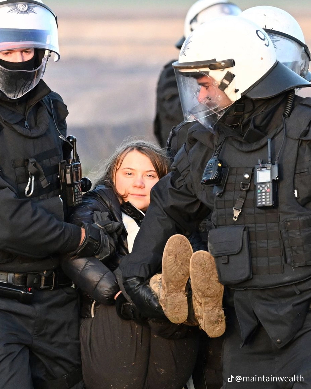 This meme features an image of a woman being carried away by riot police during a protest. The image is captioned "when you're trying to get to the front of the line but you get caught in the wrong place at the wrong time". The text is likely referencing a common experience of being stuck in a crowded situation, but in this case, it's being used to poke fun at the idea of being caught in a chaotic situation like a protest.